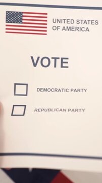 A U.S. citizen holding a ballot at a polling station during the U.S. Congressional midterm elections