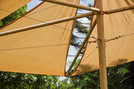 Sun shade sail structure providing protection from the sun's rays outdoors