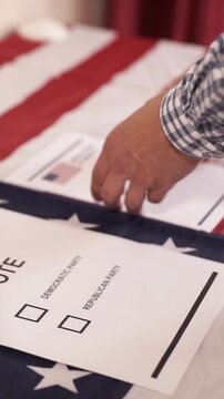 A U.S. citizen holding a ballot at a polling station during the U.S. Congressional midterm elections