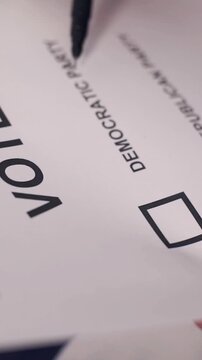 A U.S. citizen holding a ballot at a polling station during the U.S. Congressional midterm elections