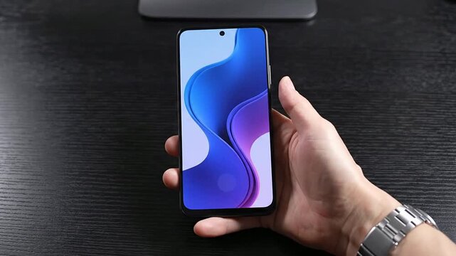 Close-Up Hand Picking Up Blank Smartphone From Sleek Black Desk With Pulse Animation Effect Indicating Interaction
