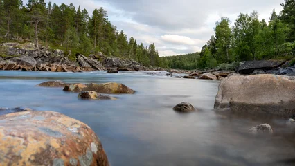 Fototapeten Wald Fluss Norway river with rocks in a forest, taking with long exposure.   © Oliver