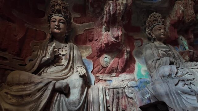 Dazu, China: Panoramic footage of a pair of bodhisattva statues, part of Baodingshan grottoes in Dazu rock carvings, famous rock art in Chongqing, China. The site date from the 9th to the 13th century