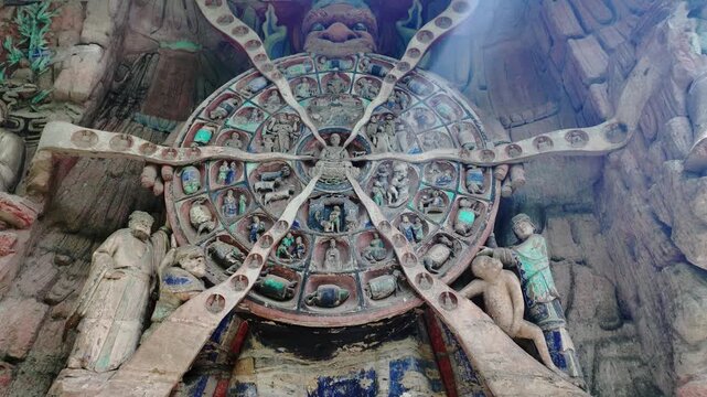 Dazu, China: Tilt down footage of the Buddhist wheel of life, part of Baodingshan grottoes in Dazu rock carvings, famous cave rock art in Chongqing, China