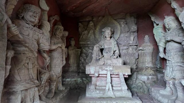Dazu, China : Pan footage of ancient Buddhist and other deities statues in the Beishan grottoes in Dazu rock carvings, dates back to the 9th century under the Tang dynasty near Chongqing, China