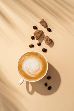 Coffee cup cappuccino foam at colored background with hard shadow.
