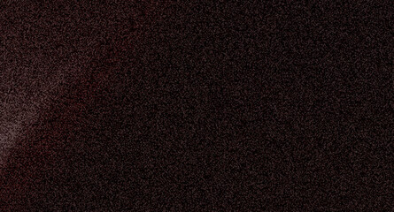 Fototapeta premium a close-up of a dark textured surface with a subtle red glow and fine grainy noise
