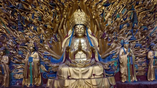 Dazu, China : Tilt down footage of thousand-hand Guanyin (Avalokitesvara), famous statue in Baodingshan grottoes date from the 9th to the 13th century located in Dazu rock carvings of Chongqing, China
