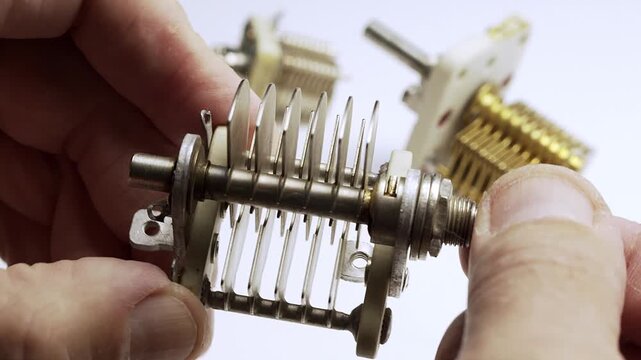 Technician operating a vintage variable condenser component.4K