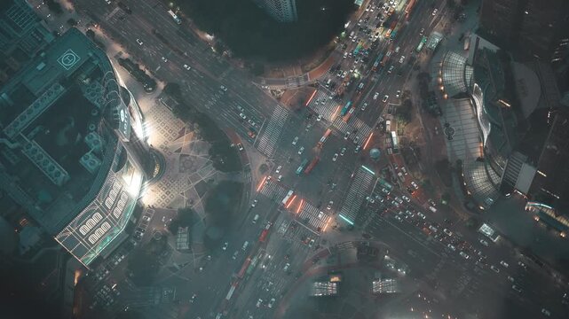 Top down night view of busy Jamsil intersection and illuminated city street in Seoul - 화려한 조명의 빌딩과 복잡한 대각선 교차로 차량 흐름이 어우러진 잠실역 사거리 야경 풍경