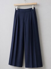 Fototapeta premium Navy Pleated Wide Leg Trousers Hanger Mockup on Natural Wood Clip Against Light Grey Wall