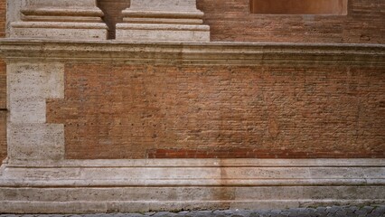 Weathered red brick wall texture with travertine stone trim, sharp detailed wall surface for architectural backdrop in an outdoor street setting  background backplate copyspace template. © Krakenimages.com
