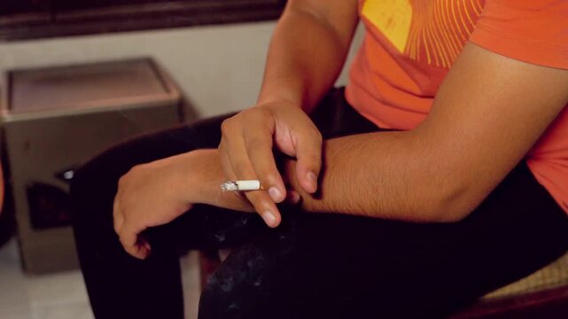 Person holding a burning cigarette in their hand smoking smoke addiction tobacco nicotine smoking smoke addiction tobacco nicotine