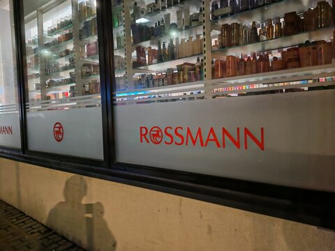 Prague,Czech Republic-April 2 2026: Rossmann drugstore entrance illuminated at night with branded storefront and retail windows