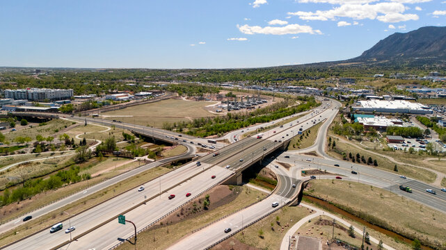Aerial view of highway overpass bridge in Colorado Springs with Cheyenne Mountain backdrop