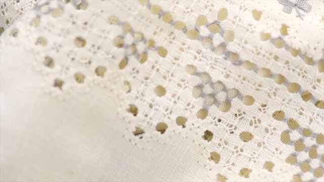 Cross-stitch on linen fabric, handmade cross stitch texture background, natural eco folded linen tablecloth. Bio textile material backdrop, canvas top view, close up, rotating  