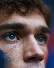 Naklejka premium French supporter portrait capturing intense focus and hope during a high-stakes football match