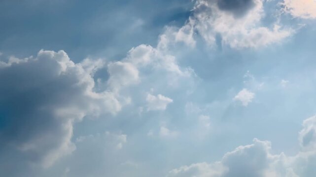 Ultra HD 4K dramatic sunbeams emerging from behind dark clouds above Jakarta, Indonesia. Suitable for weather, spiritual, background, climate, and inspirational themes.