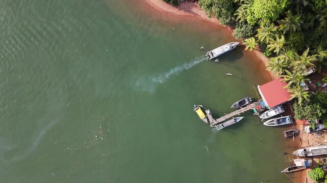Boats Moored Near Lush Coastline of Batam, Indonesia - 4K Drone Footage