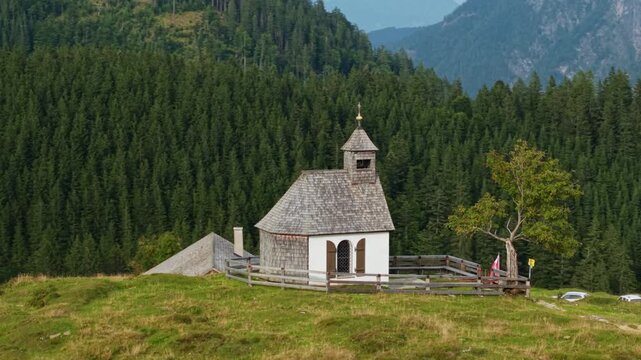 Drone orbit right of Postalmkapelle chapel and alpine hut at Postalm, Austria