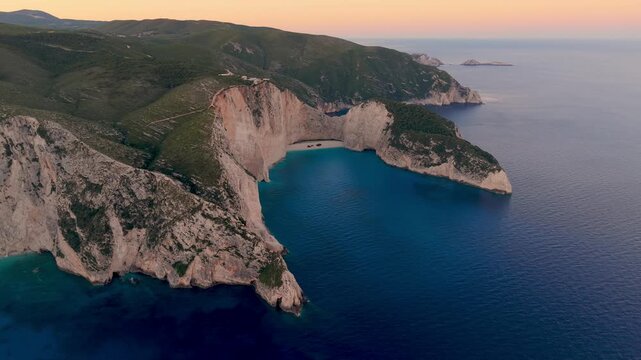 Experience the stunning beauty of Navagio Beach, known for its iconic shipwreck and surrounding cliffs. Witness the vibrant colors of sunset illuminating the azure waters of Zakynthos.