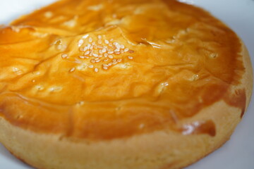 Fototapeta premium Close up of traditional Chinese pastry flaky cake topped with white sesame seeds