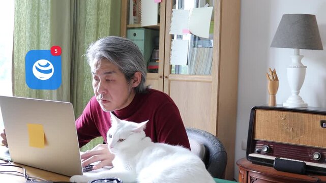 A mature Asian man with white hair using a laptop at home next to his white cat, displaying a 3D tracked fast spinning globe world map notification pop up and red counter.