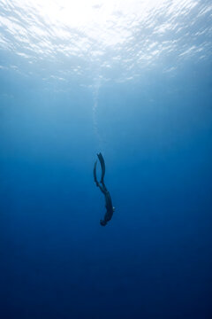 Serene Freediver Descending Into Deep Blue Silence