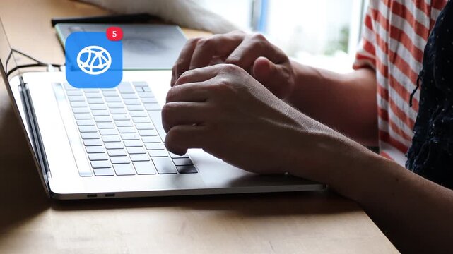 Close up of an Asian man hands typing on a laptop keyboard in casual wear, featuring a 3D tracked global connection nodes earth network notification pop up and red counter.