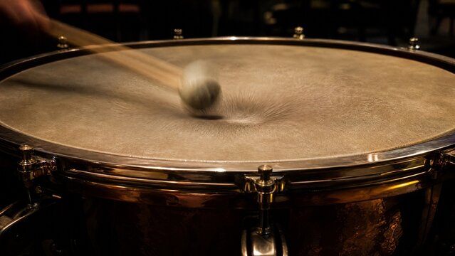 timpani. Timpani drumhead with blurred mallet impact and deep vibration. product launch decks, UI/UX mockups, designed for product launches and innovation pitches, clarifies data.