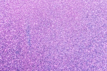 Fototapeta premium Textured purple glitter background, with subtle sparkle effects
