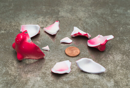 Red Smashed Piggy Bank with one cent