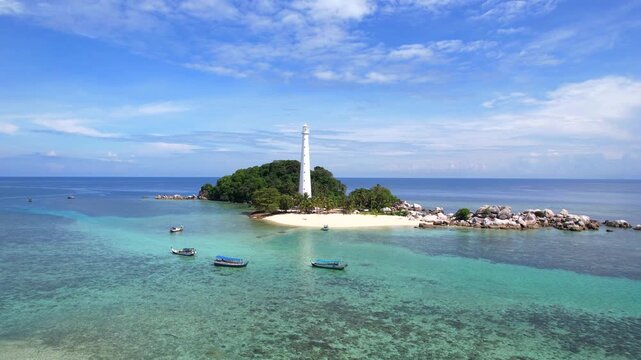 Belitung Island tropical landscape of Lengkuas Island from above, showing the iconic lighthouse surrounded by clear blue ocean