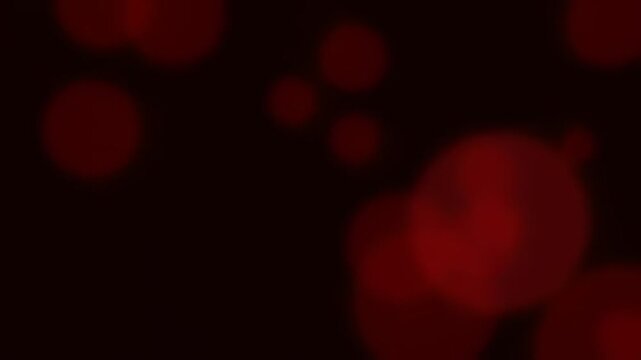 Abstract red bokeh lights on dark background for festive design