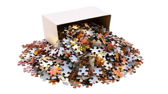 Pile of colorful puzzle pieces spilling from cardboard box