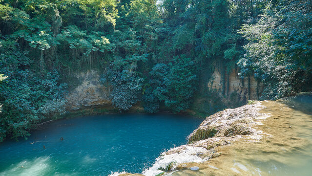 Waterfall and turquoise pool at Sentier Elsa nature reserve in Tuscany Italy
