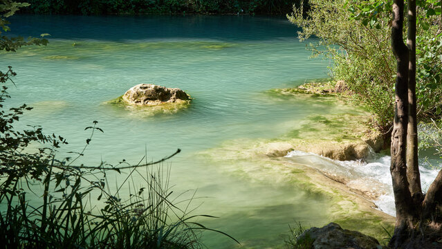 Waterfall and turquoise pool at Sentier Elsa nature reserve in Tuscany Italy