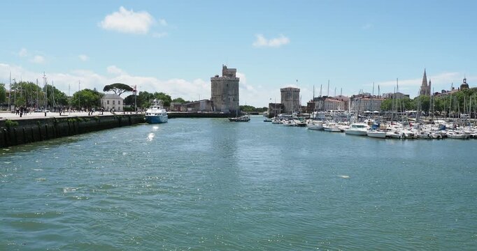 The Old Port of La Rochelle in Charente-Maritime. The marina, lined with historical monuments facing the iconic towers and surrounded by lively promenades and boat trips
