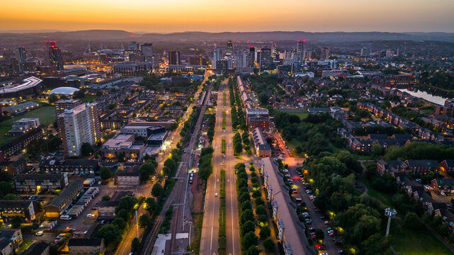 Aerial view of Cardiff city centre skyline at dusk with the Butetown neighbourhood in the foreground.