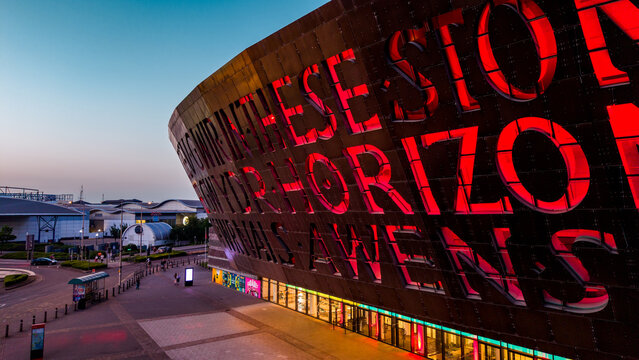 Aerial view of the illuminated Wales Millennium Centre at twilight in Cardiff Bay