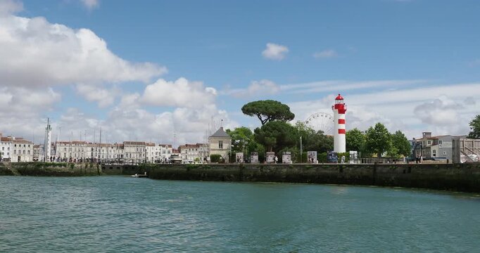 Old Port Basin 'Vieux Port'  of La Rochelle in Charente-Maritime. View of the Red Lighthouse and Old Port office, the Ferris wheel and the Green Lighthouse of Quay Valin