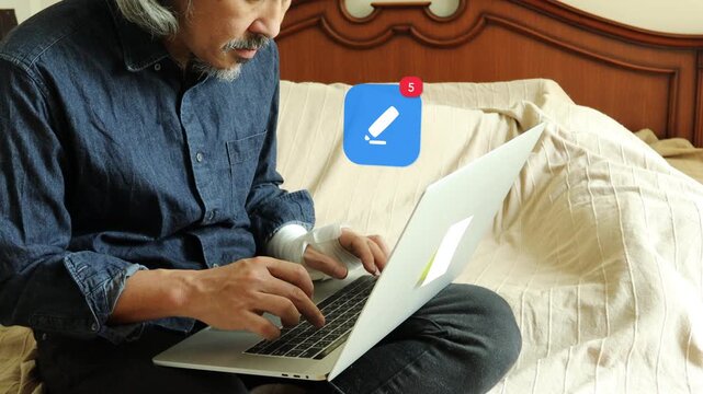 An injured mature Asian man with a hurt hand using a laptop in bed, featuring a 3D tracked pencil document writing notification pop up and red counter.