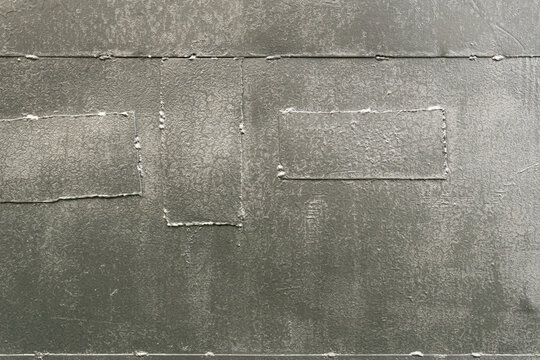 Silver painted metal wall texture with welded patches and seams
