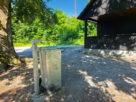 germany, silver metal trash bin in pristine forest environment promoting sustainable tourism responsible waste disposal and clean nature