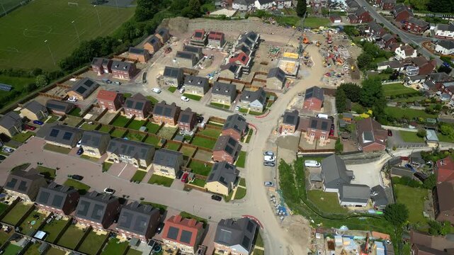 This aerial view shows the Noble Homes housing site in Knottingley, UK. Construction is ongoing with homes and roads in progress. The layout of the site is clearly visible from above