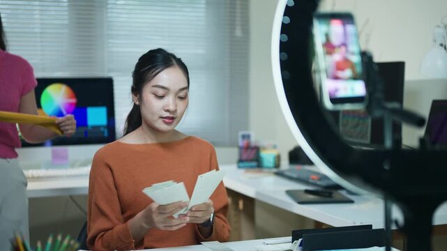 Young Asian Woman Content Creator Recording Video with Ring Light and Smartphone in Home Studio Setup