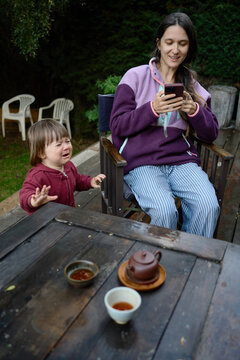 Mother and Child Share a Moment Outside During Tea Time in the Garden