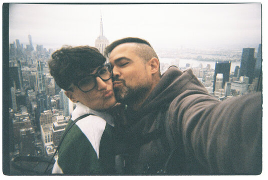 Couple kissing building selfie New York City skyline