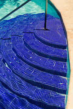 Entrance steps to a hotel pool on a sunny day