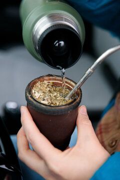 Pouring water on yerba mate